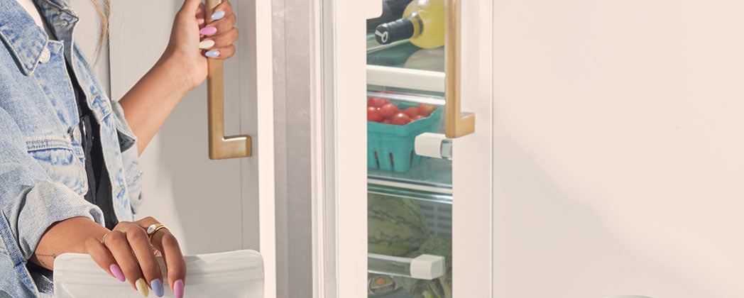 woman opening fridge door